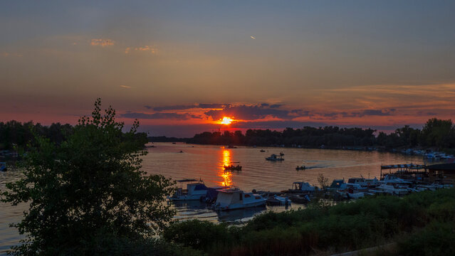 Sunset on Sava River in Sremska Mitrovica, Serbia, with boats