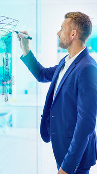 Man drawing graph on glass