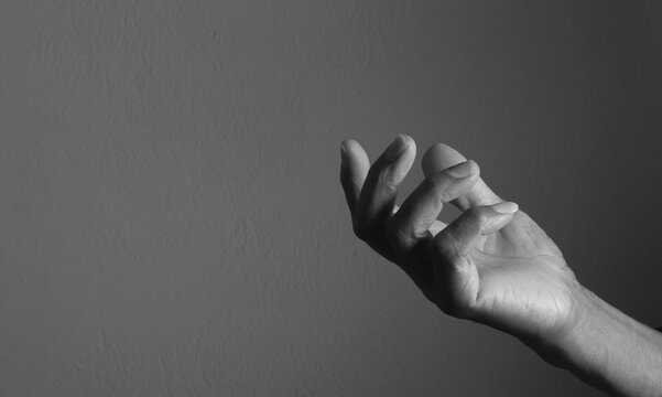praying to god with hands showing his religious faith with God Caribbean man praying with background with people stock photo stock image