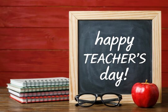 Happy teachers day greeting with a chalkboard, notebooks, glasses, and a red apple