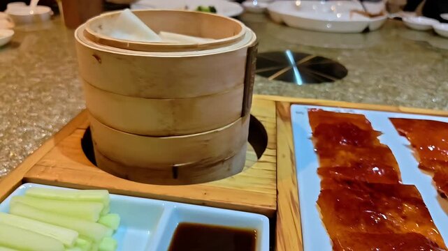 Roasted crispy Peking duck skin served with dipping sauce, vegetables, and chun bing spring pancakes, Cantonese Chinese Restaurant Food, Lunar New Year,