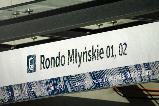 Horizontal urban detail photo of tram stop sign under glass shelter Rondo Mlysnkie in Krakow, Poland real photography