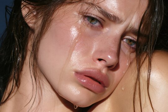 Woman crying expressing sadness and emotional grief