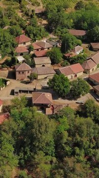 Aerial around view of old rustic vintage houses with wine cellars in Rogljevacke pivnice in Negotin region of Serbia. Vertical video 4k
