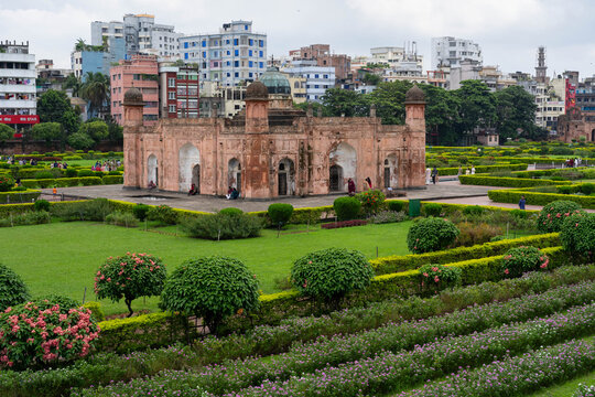 Dhaka, Bangladesh - 15 August 2026: View of the historic Lalbagh Fort, a 17th-century Mughal complex, surrounded by manicured gardens and lush lawns, with the Dhaka city skyline in the background.
