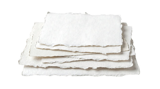 A stack of white handmade torn paper sheets with raw deckle edges isolated on transparent background