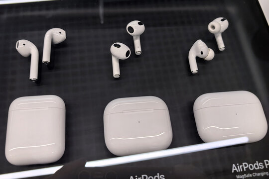 Different models of wireless earbuds displayed in an electronic store