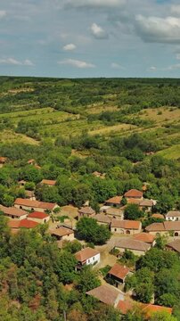 Aerial around view of old rustic vintage houses with wine cellars in Rogljevacke pivnice in Negotin region of Serbia. Vertical video 4k