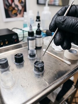 Close Up of Professional Artist Mixing Ink in Tattoo Studio