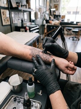 Professional Tattoo Artist Inking Detailed Mandala Design on Arm