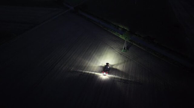 Nighttime Crop Spraying with a Large Agricultural Sprayer Vehicle, Aerial Drone View