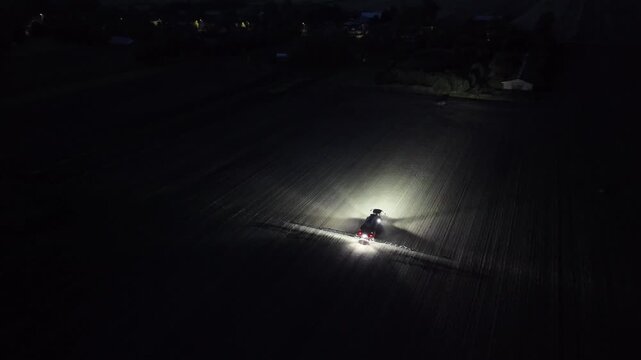 Nighttime Crop Spraying with a Large Agricultural Sprayer Vehicle, Aerial Drone View