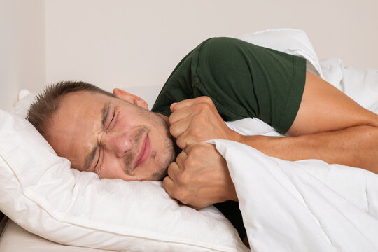 Sick Man Suffering from Breathing Difficulty While Lying in Bed