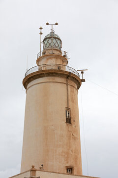 Historic Coastal Lighthouse Tower Under Overcast Sky