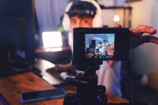 Person streaming music creating content for online audience