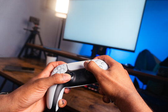 Player holding controller while gaming in studio setup