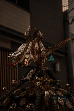 Taito City, Japan - 15 May 2026: View of the ornate golden phoenix ornament atop a traditional mikoshi portable shrine in Asakusa, featuring intricate metalwork.