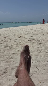 ​POV Close Up of Sandy Feet Relaxing on White Sand Beach, First Person View, Vertical 4K Video