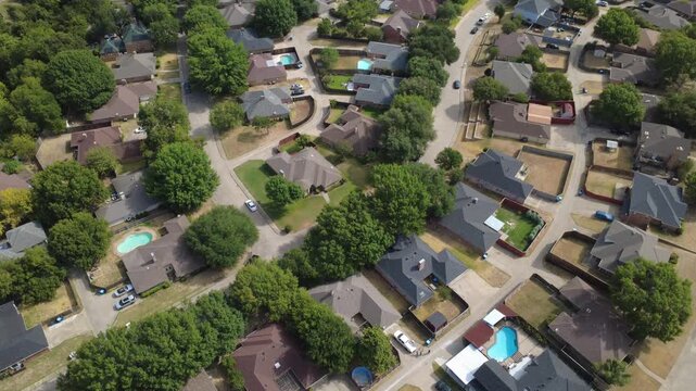 Mesa Verde neighborhood avenues intersect near Ten Mile Creek greenway in southern suburbs. Private backyard pools, brick facades, concrete driveways show classic community life, DeSoto, TX