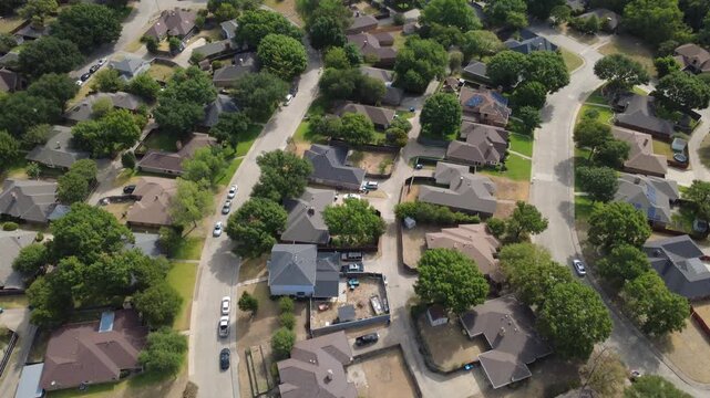 Curving neighborhood lanes connect brick residences within Mesa Verde community in Dallas suburbs. Solar panels, fenced backyards, paved driveways emphasize modern home design, DeSoto, Texas