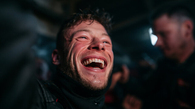 Excited Young Man Laughing Joyfully at Nightclub Concert