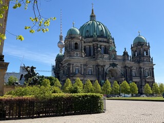 Berlin Cathedral Exterior with TV Tower and Lustgarten Greenery Under Clear Blue Sky © Chris
