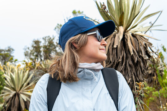 Woman hiking enjoying high andean paramo landscape with frailejones