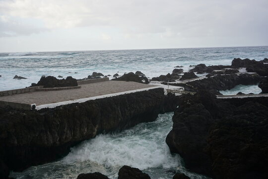 Rocky coast with tidal pools and crashing waves