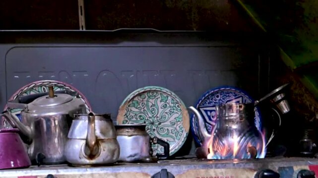 Marrakech, morocco. August 8, 2026. Traditional moroccan mint tea preparation in the medina of marrakech. Silver teapots and ceramic plates for sale in a typical souk shop