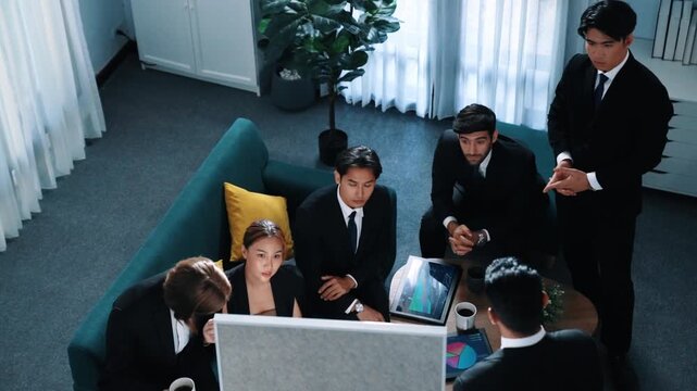 Top view of smart business team looking financial statistic while executive manager raise hand and point at marketing data on whiteboard. Happy diverse group brainstorm creative idea. Directorate.