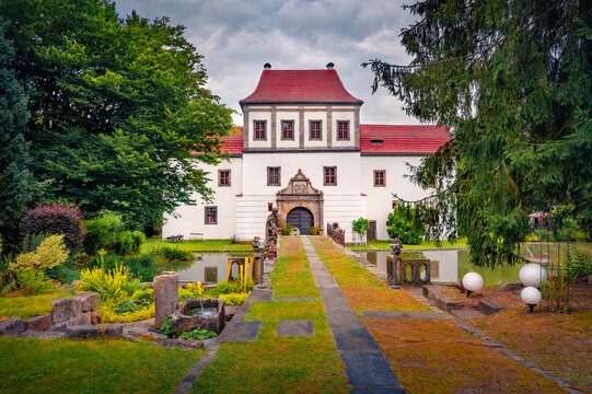 Picturesque evening view of Moated Castle Hainewaldes. Wonderful summer cityscape of Hainewalde - town on the river Mandau, Bundesland of Saxony, Germany, Europe. Traveling concept background.