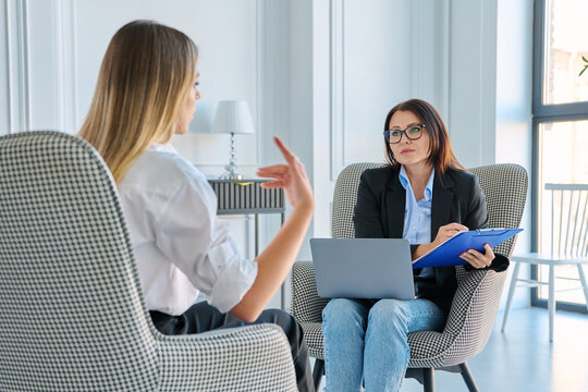 Attentive female recruiter listening to job applicant during interview in office