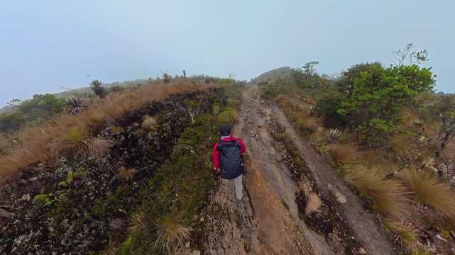 Hiker walking on a trail in the colombian paramo