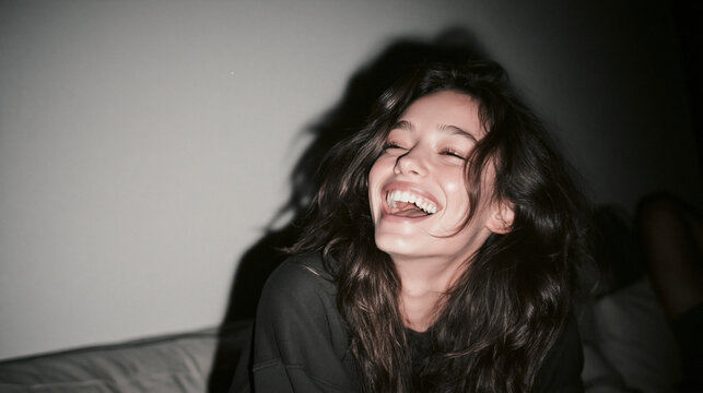 Carefree Young Woman Laughing Joyfully with Flash Lighting