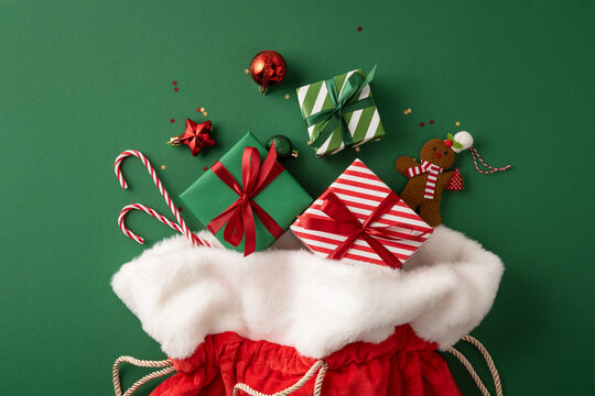 Merry Christmas gift sack with Santa present, candy canes and gingerbread for Happy New Year celebration