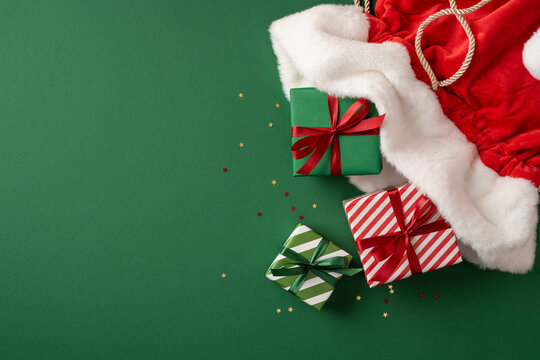 Merry Christmas and Happy New Year with Santa Claus presents and wrapped gifts on green background