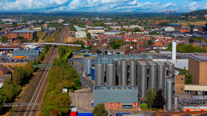 Large metal fermentation silos and railway line at brewery plant © Андрей Нелупов