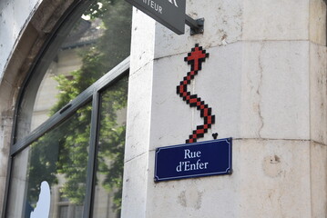 Mosaïque murale dans le style Pixel Art, représentant une queue de diable, en lien avec le nom de la rue d'Enfer, à Genève. © Valentin