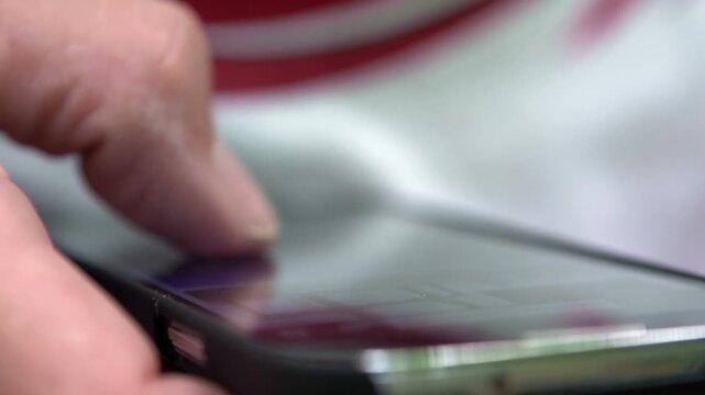 Elderly man using smart phone macro shot of hand
