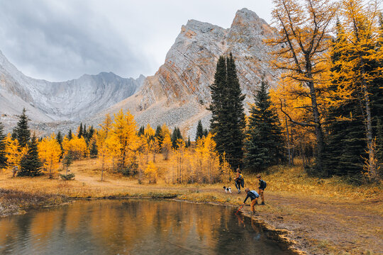 Woman and children exploring a valley with a pond in Kananaskis, Alberta