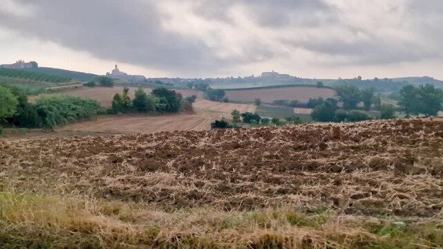 Plowing Field and Rolling Hills in Rural Monferrato Countryside, Italy