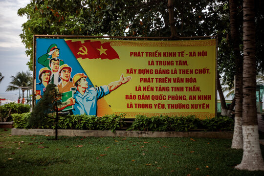 Vietnamese Political Propaganda Banner with Revolutionary Imagery and Slogans Displayed Outdoors