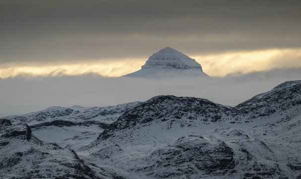 One of the three Tee Kroner (Three Crowns) mountains, partly shrouded in cloud, Kongsfjord or Kongsfjorden, the Svalbard archipelago, Svalbard, Norway