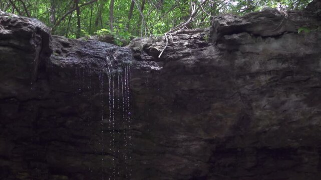 Small waterfall with reflection in cave
