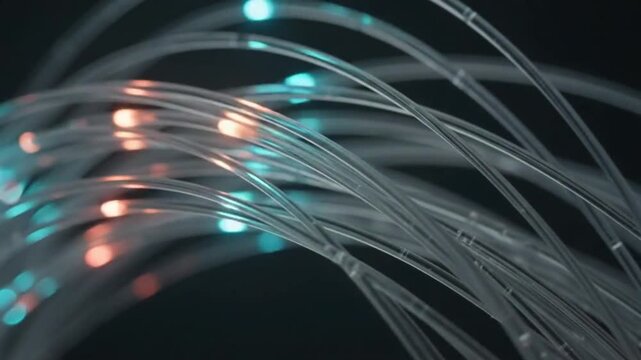 Close-up view of glowing fiber optic cables transmitting data with blue and orange light.