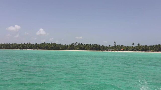 Breathtaking view of Saona Island in Punta Cana, Dominican Republic &mdash; a Caribbean paradise known for its crystal-clear turquoise waters, powdery white sand, and swaying palm trees. Tourist boats ancho