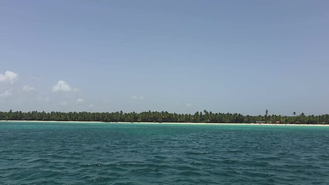 Breathtaking view of Saona Island in Punta Cana, Dominican Republic &mdash; a Caribbean paradise known for its crystal-clear turquoise waters, powdery white sand, and swaying palm trees. Tourist boats ancho