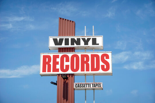 Retro vinyl records and cassette tapes sign