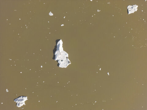 Aerial view of ice chunks floating in a glacial lagoon in Iceland.
