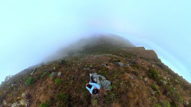 Woman hiking enjoying the foggy mountain view in a paramo